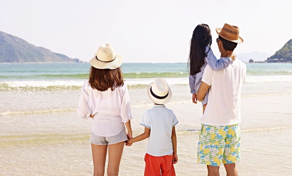 a picture of a family enjoying a day at the beach wearing matching shirts