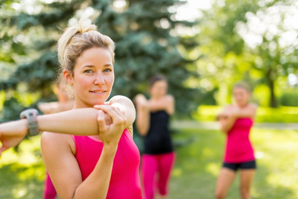 A picture of woman outside stretching before exercise